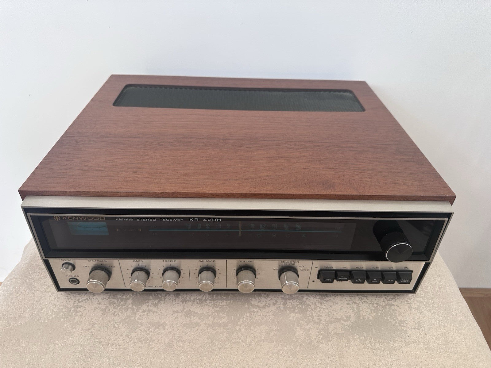 Kenwood KR-4200 receiver with wooden case and silver front panel, vintage stereo hi-fi amplifier – front angled view
